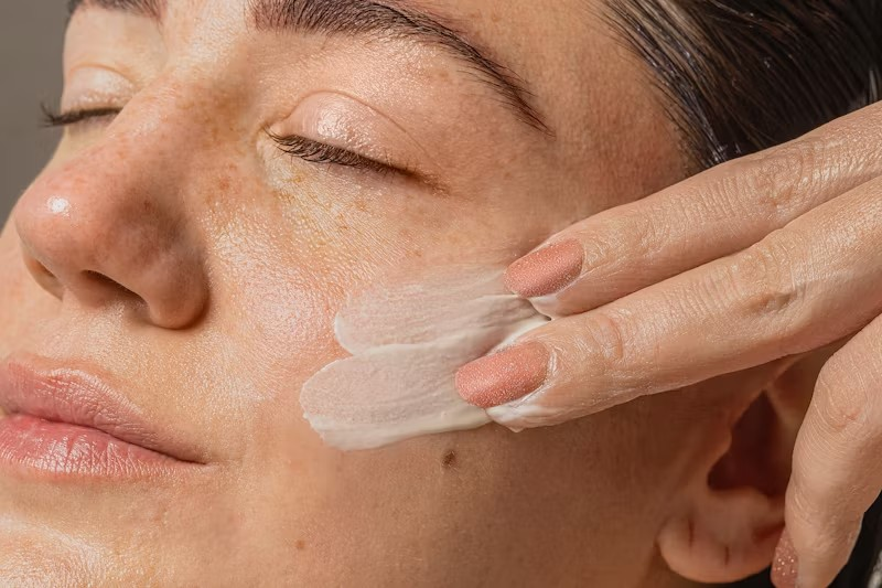 Woman uses pimple patches on her face.